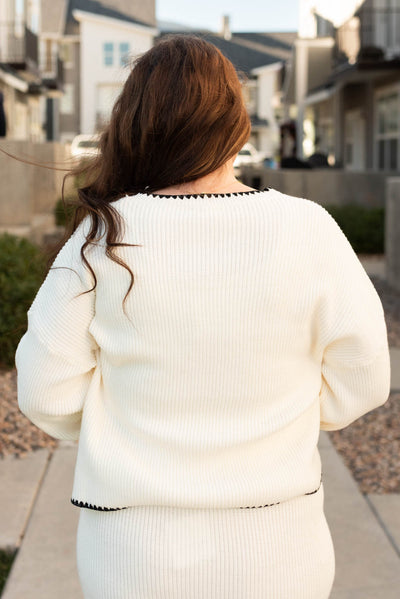 Back view of the cream knit sweater in plus size