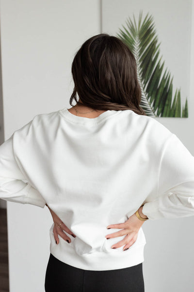 Back view of the white Christmas bow sweater