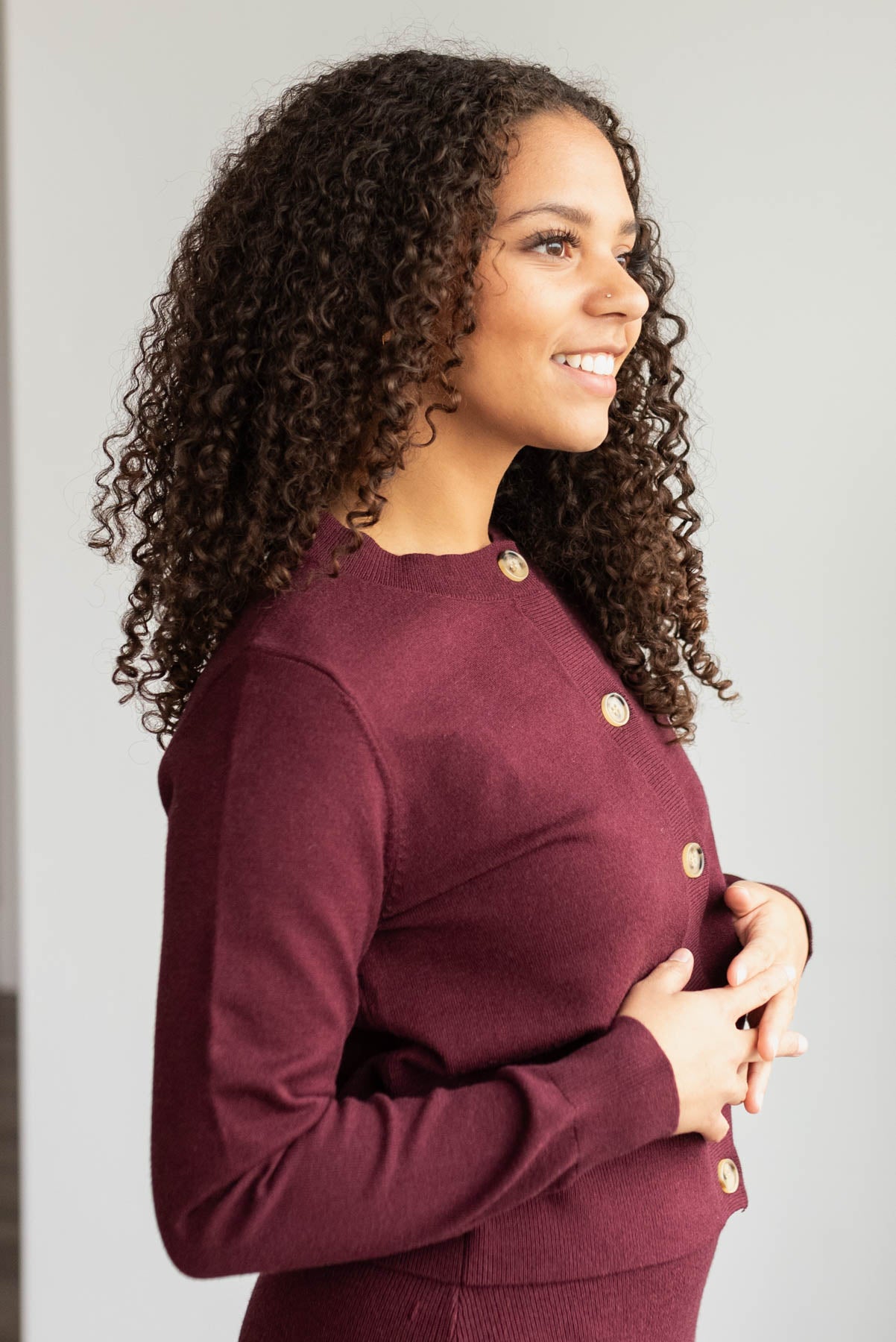 Side view of the burgundy knit sweater