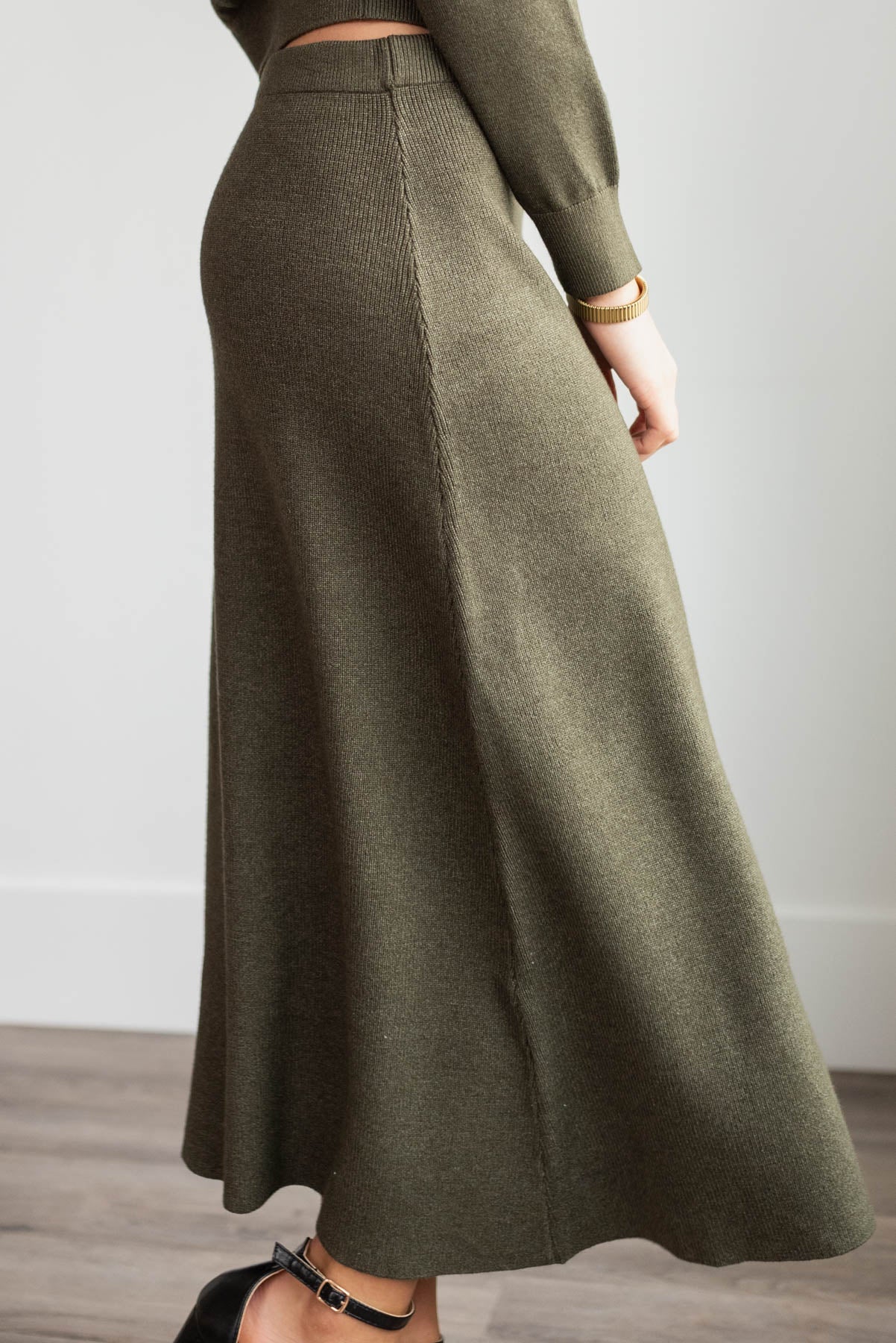 Side view of the dark olive knit skirt