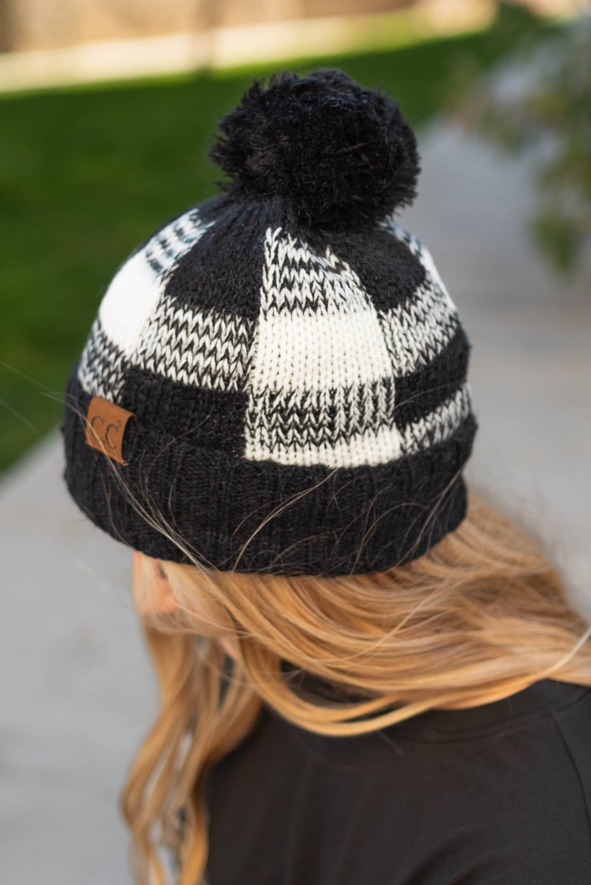 Side view of a black plaid C. C. beanie