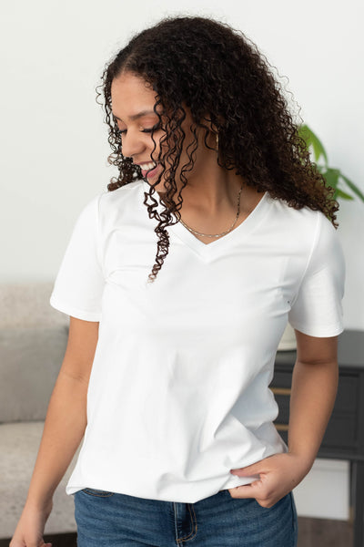 White v-neck top with a scoop hem