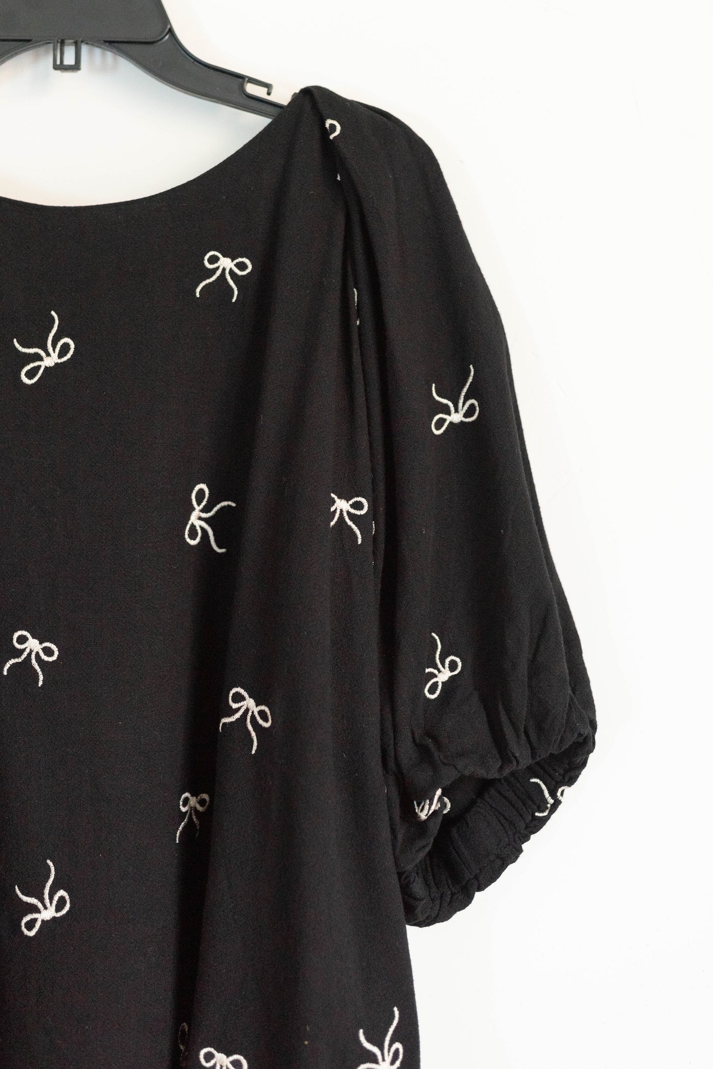 Close up of the fabric on the black embroidiered bow top