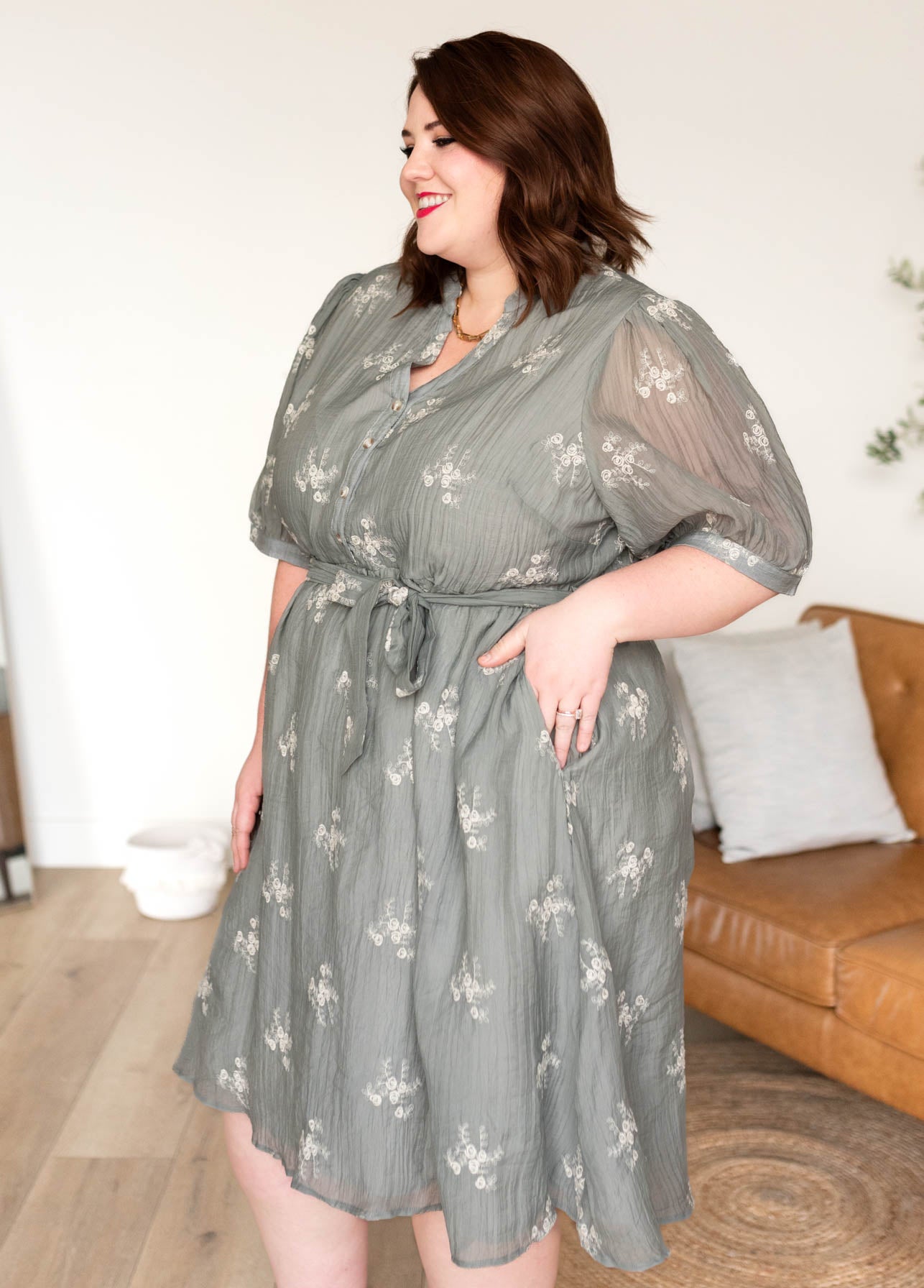 Side view of the plus size dusty sage embroidered dress with pockets