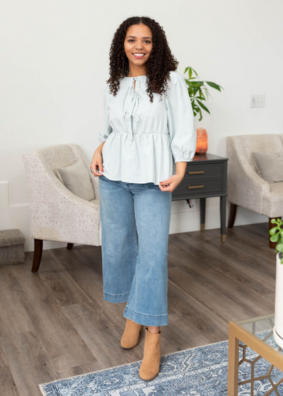 LIght blue stirpe top with long sleeves and ties down the front