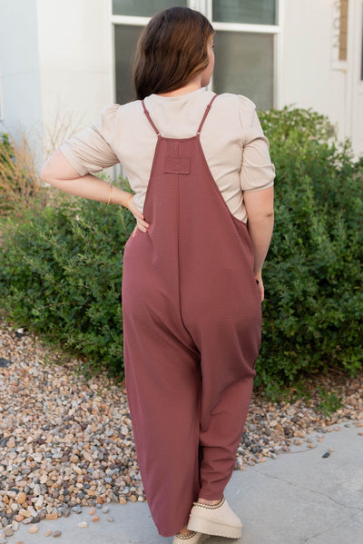 Back view of the plus size mahogany woven overalls