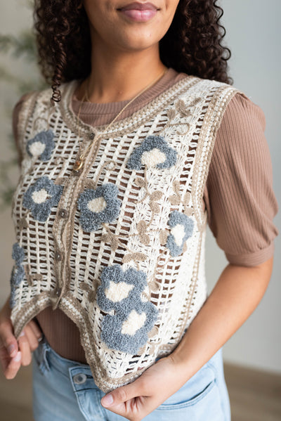 Close up of the cream floral crochet vest