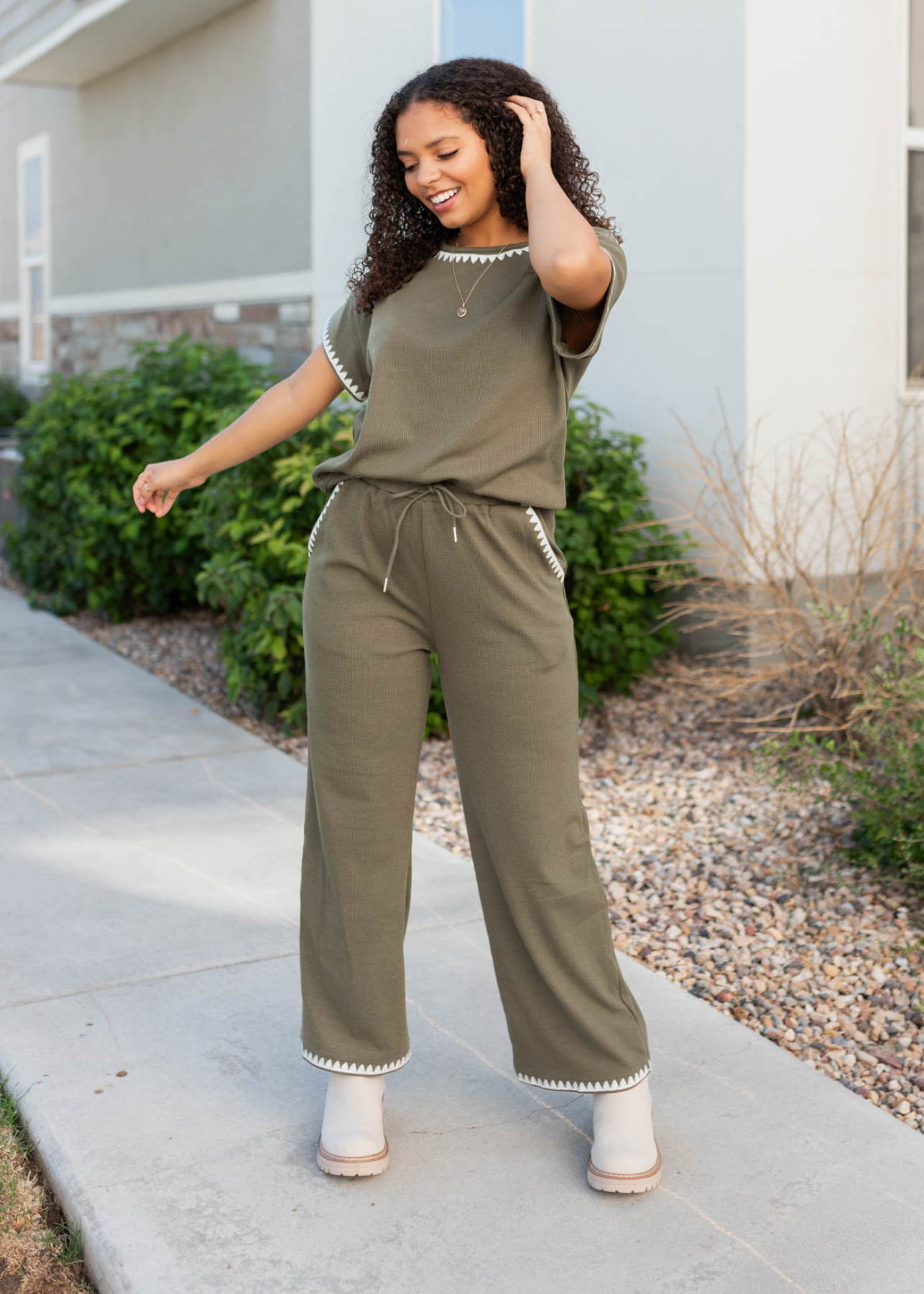 Olive embroidered pants with embroidery on the pockets