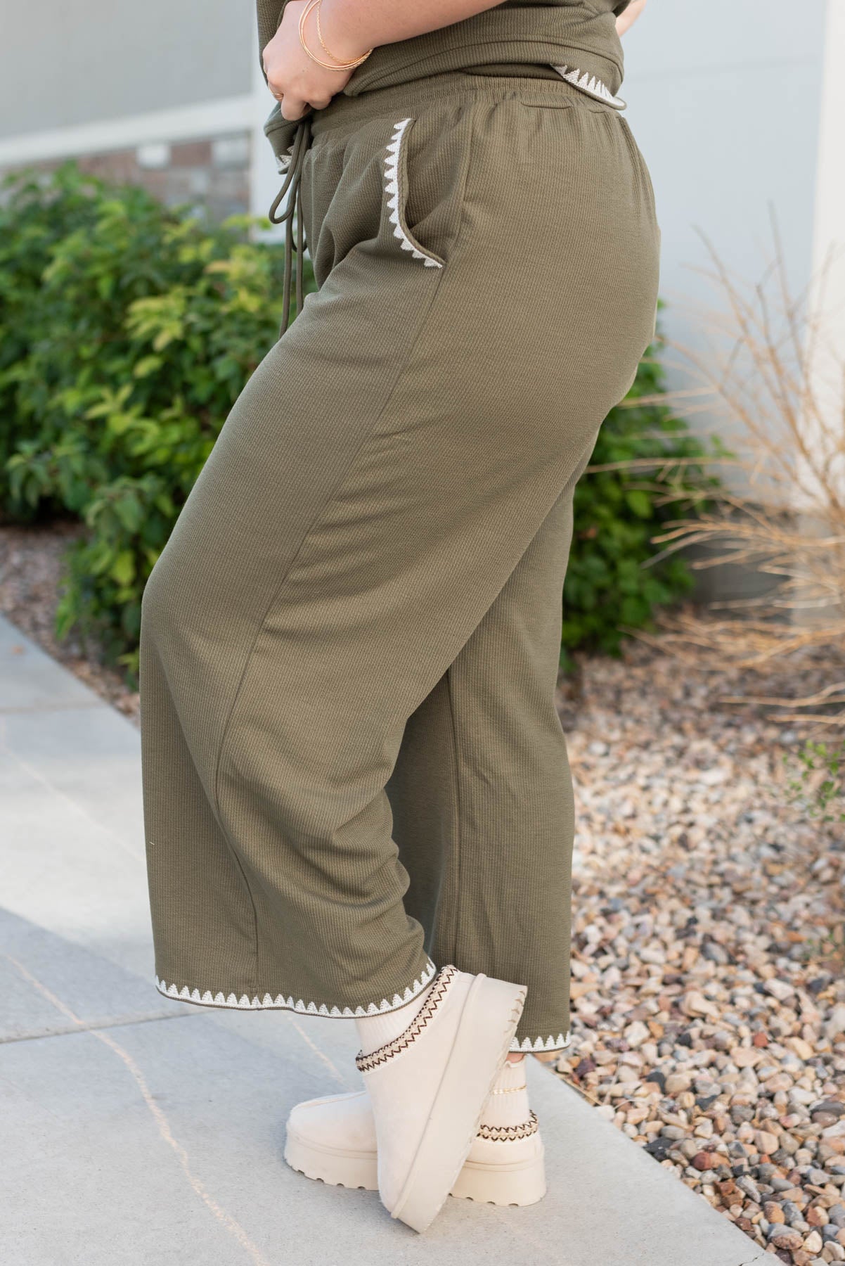 Side view of the olive embroidered pants in plus size