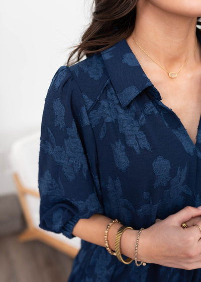 Close up of the fabric on the navy floral collared dress