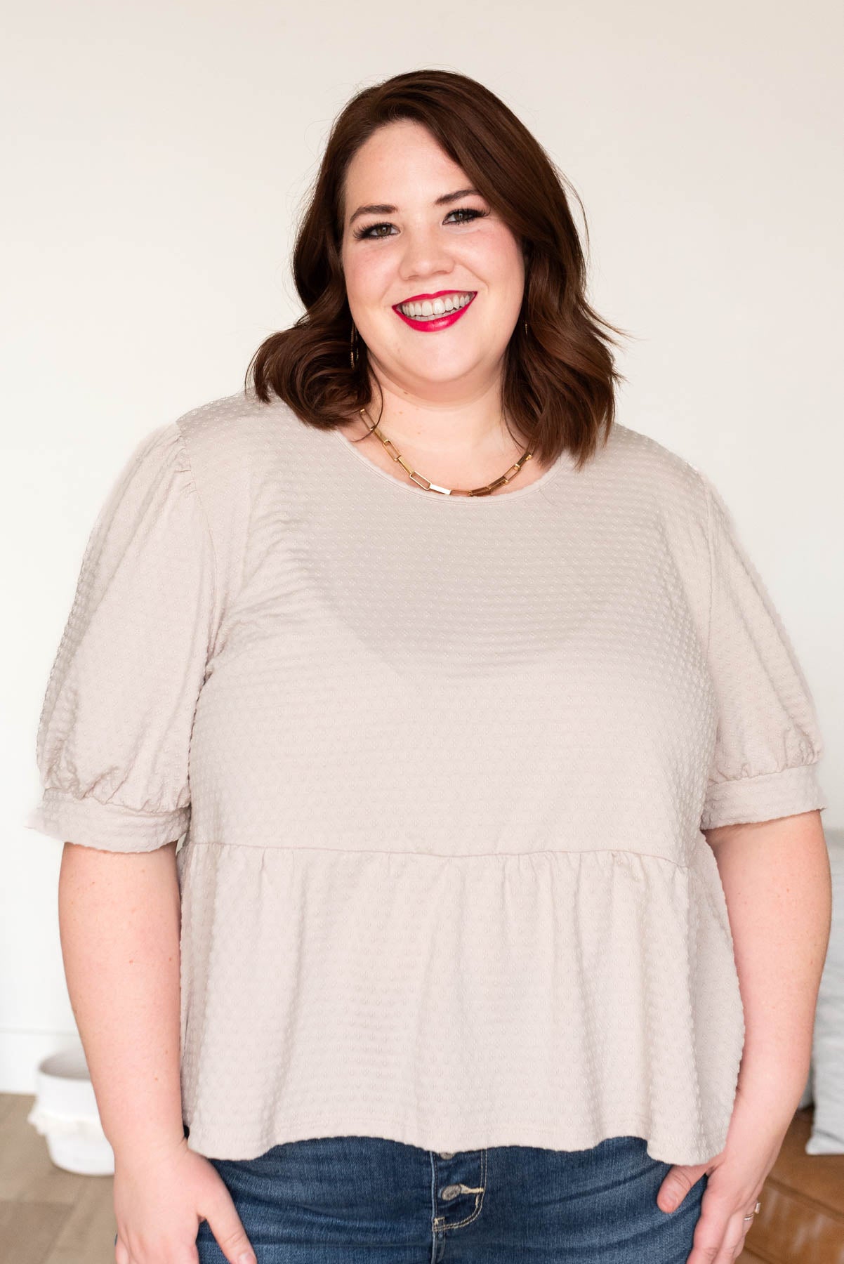 Plus size beige tiered top with cuff on sleeve