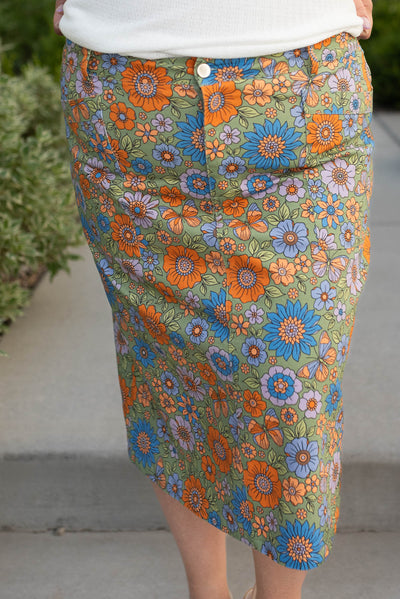 Front view of the plus size green multi floral jean skirt