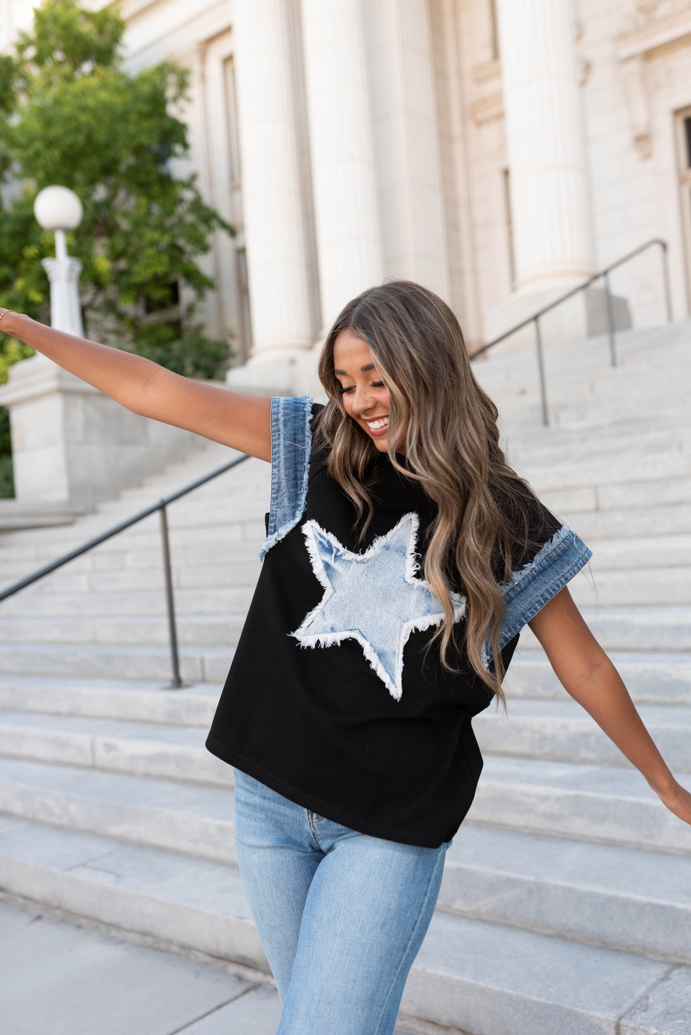 Front view of the black denim star top