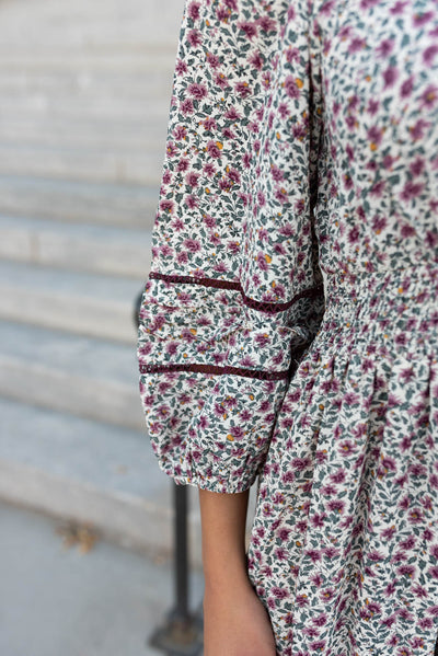 Close up of the burgundy detail on the sleeve of the burgundy floral dress