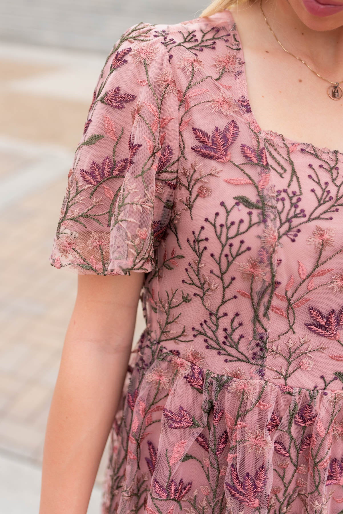 Close up of the fabric and sleeve on the antique pink embroidered dress