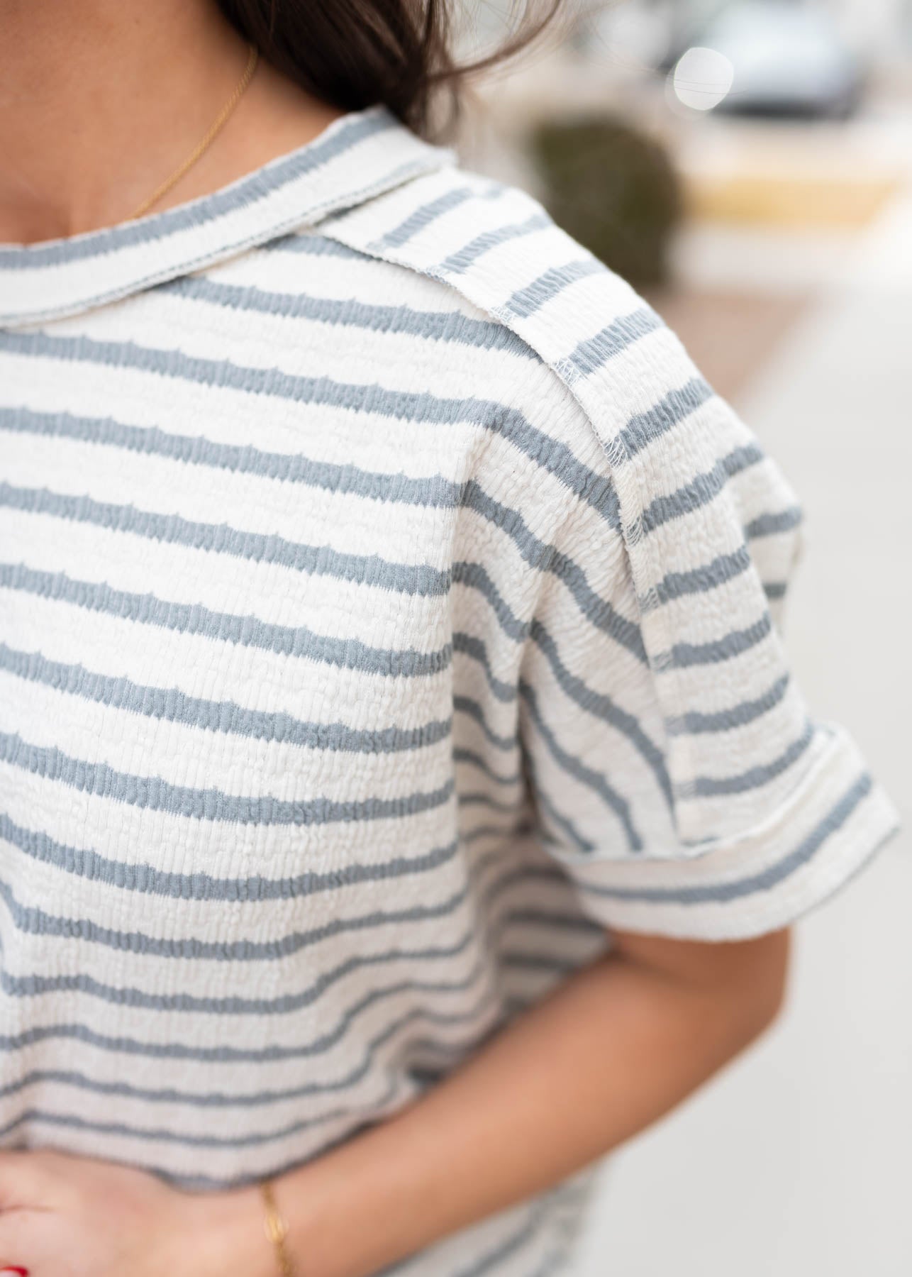 Close up of the sleeve and fabric on the blue grey stripe top