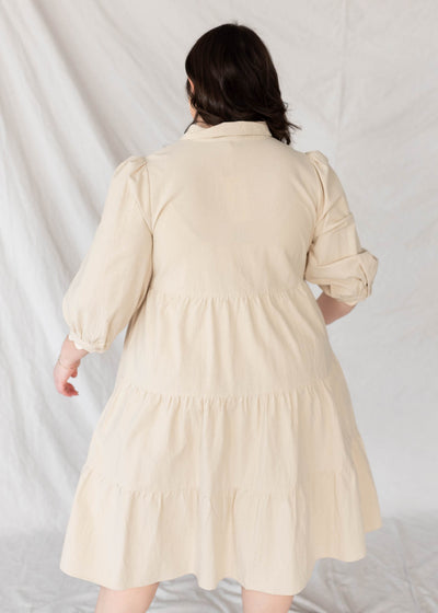 Back view of the plus size beige button down dress