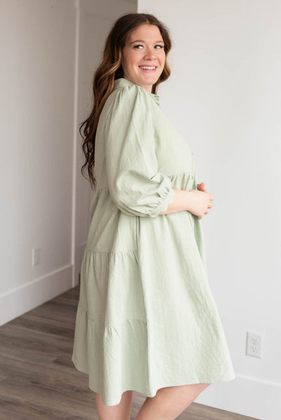 Side view of the green button down dress in plus size