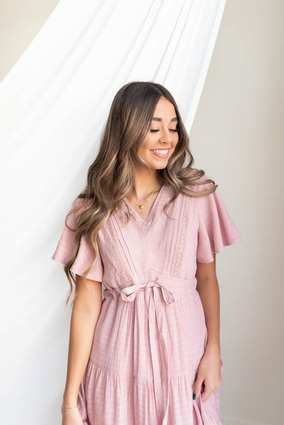 Short sleeve blush textured tiered dress with a tie at the waist