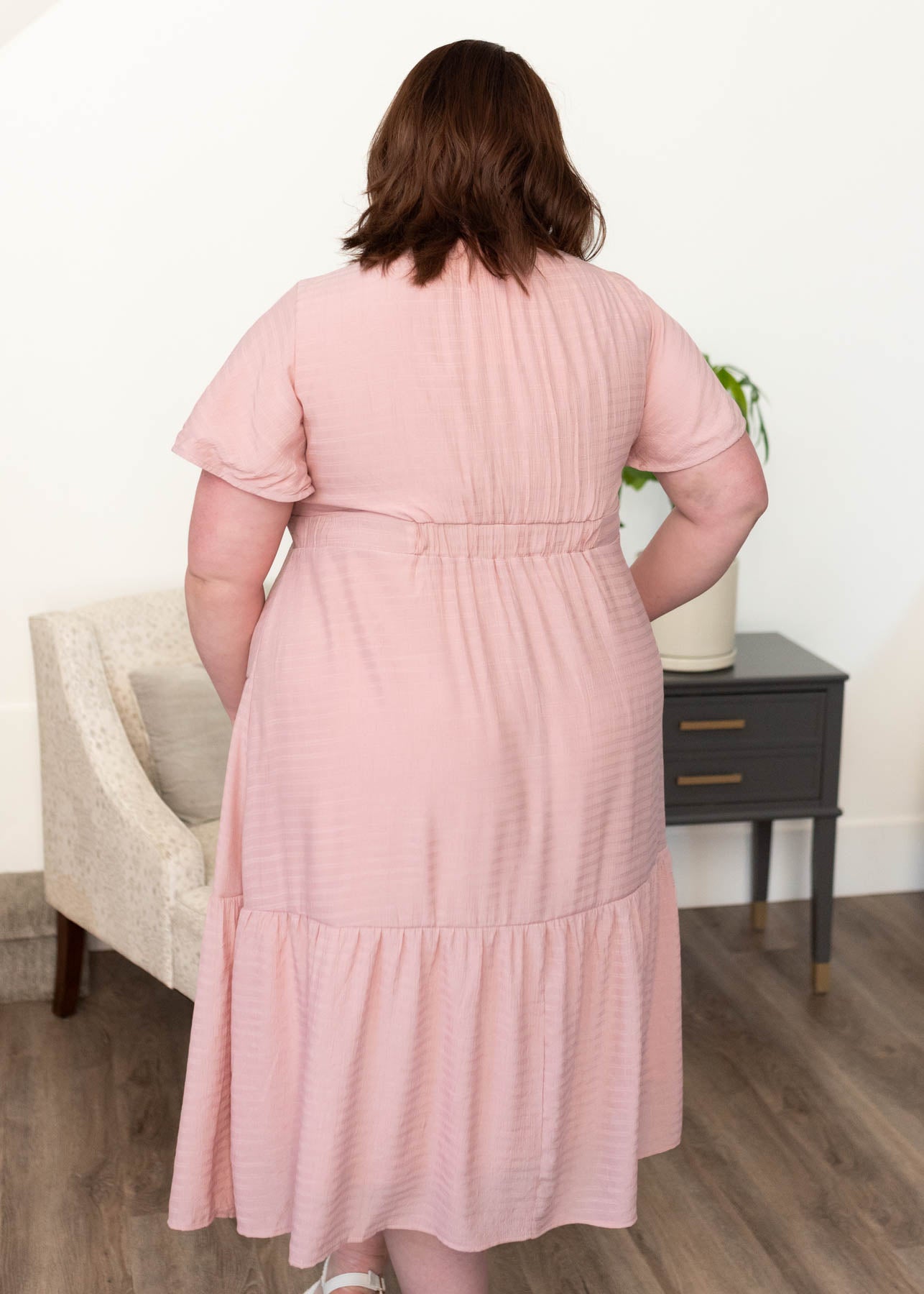 Back view of the plus size blush textured tiered dress