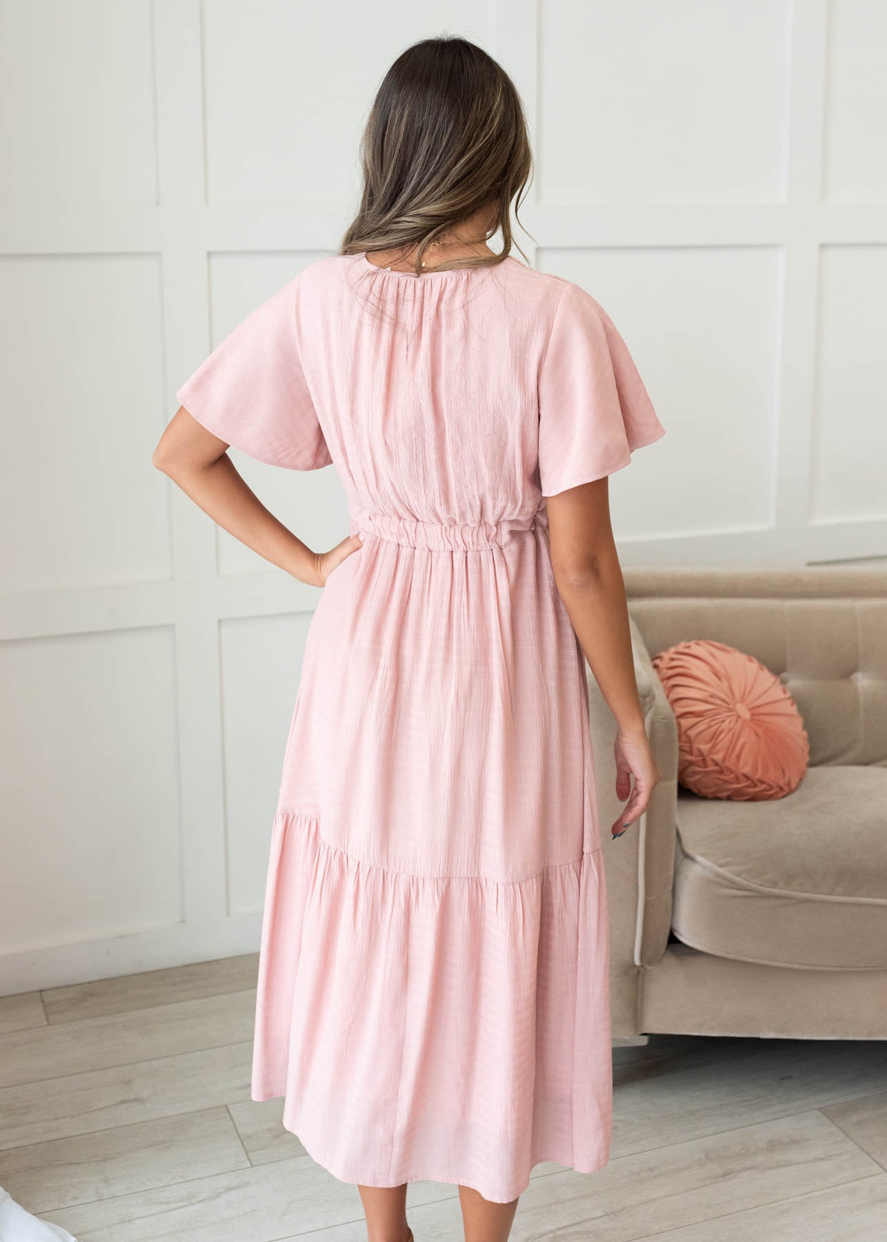 Back view of the blush textured tiered dress