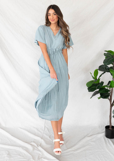 Dusty blue textured tiered dress with a tie at the waist