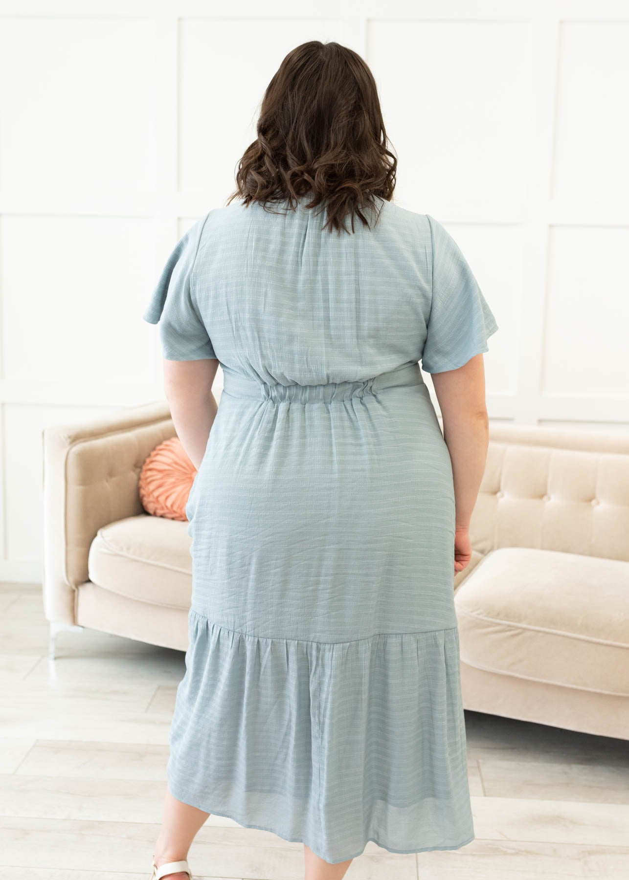 Back view of the dusty blue textured tiered dress in plus size