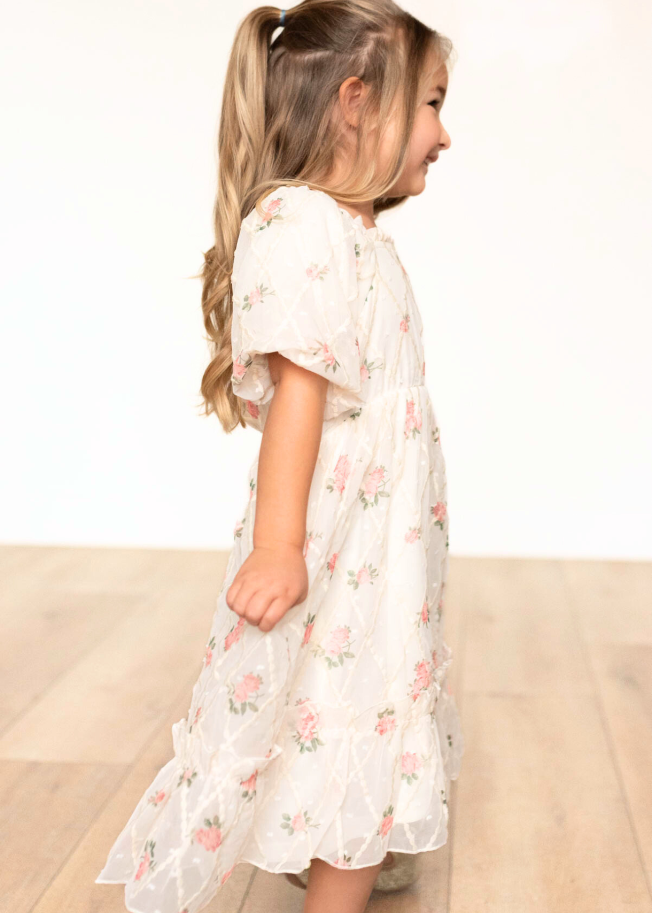 Side view of the cream rose little girl dress with short sleeves