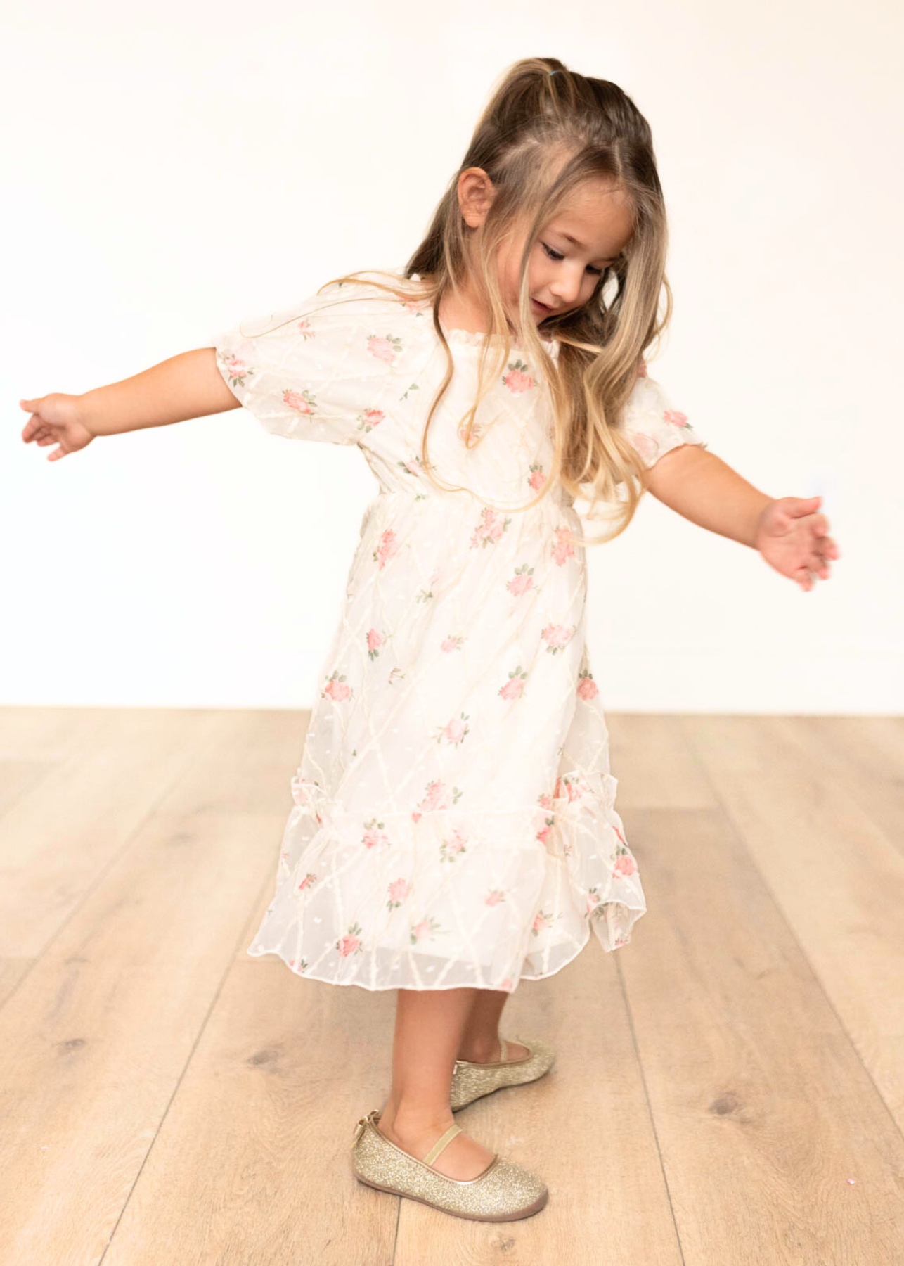 Side view of the cream rose little girls dress