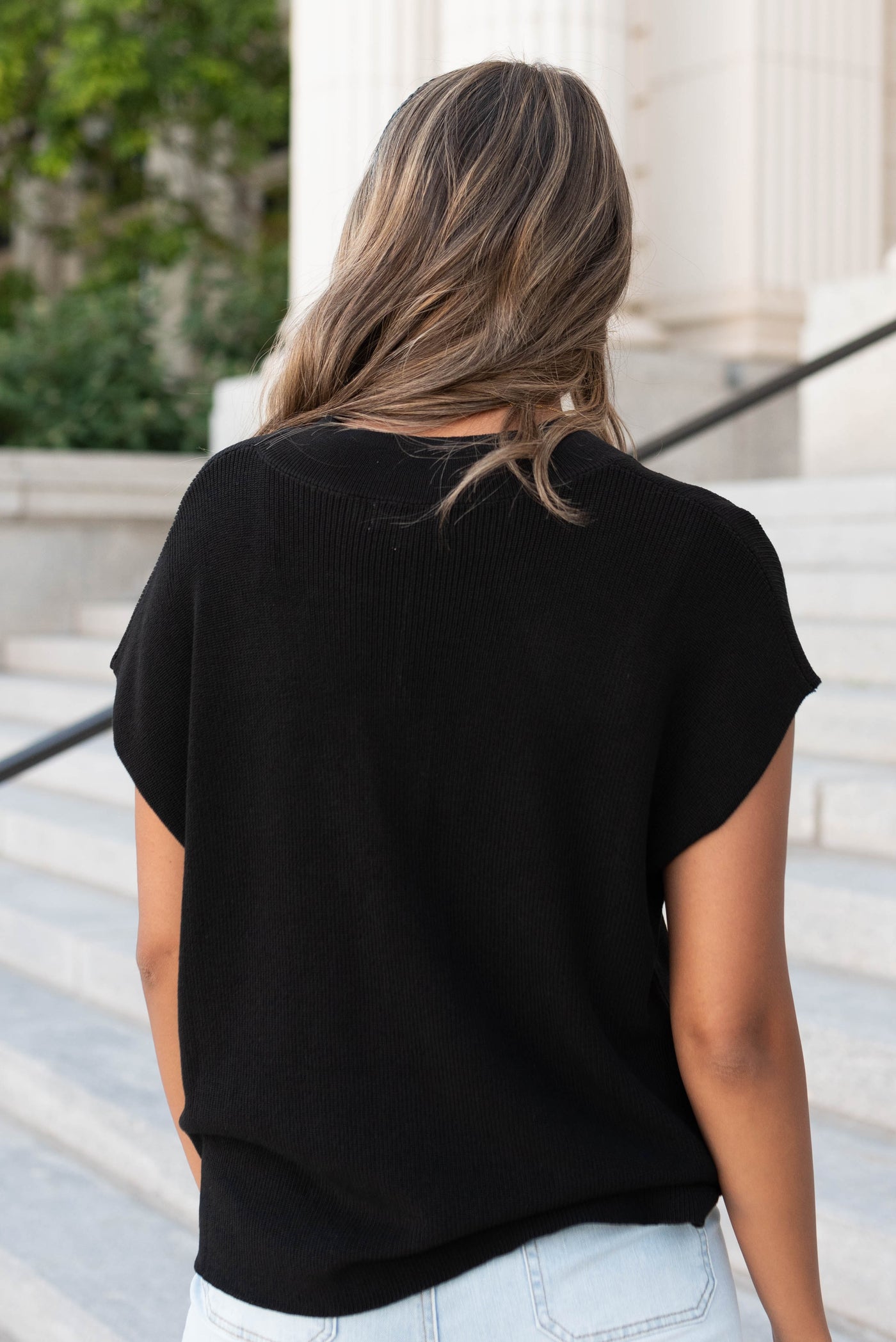 Back view of the black knit cap sleeve top