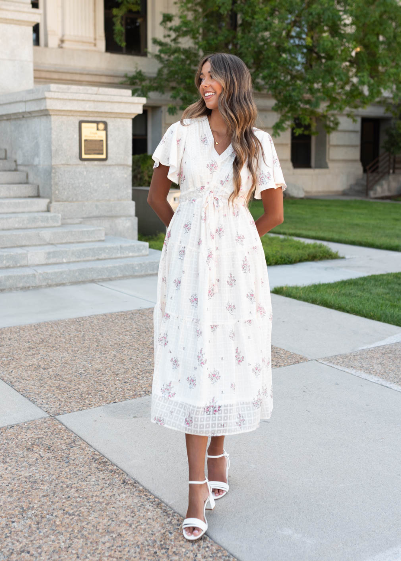 Cream floral tiered dress with a small clusters of pink flowers