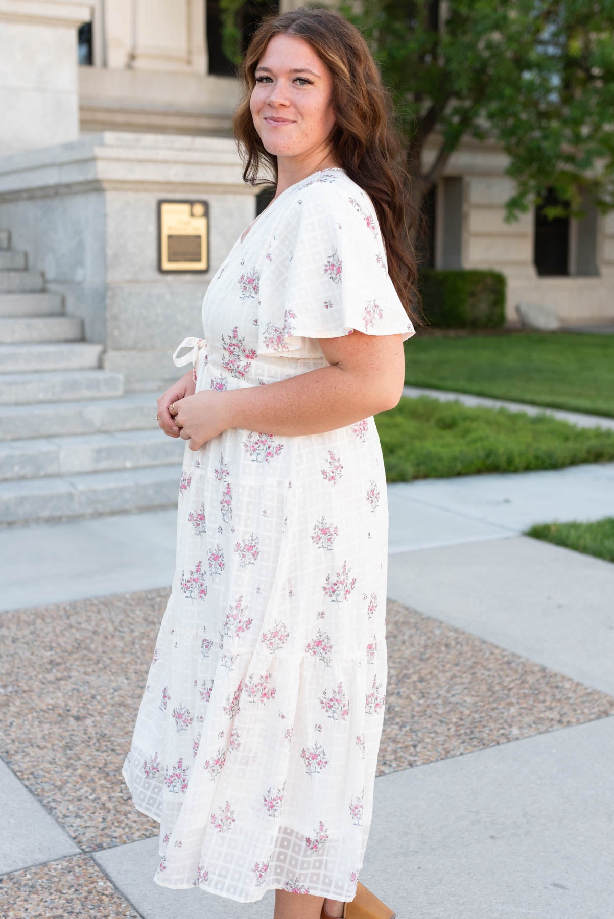 Side view of the plus size cream floral tiered dress