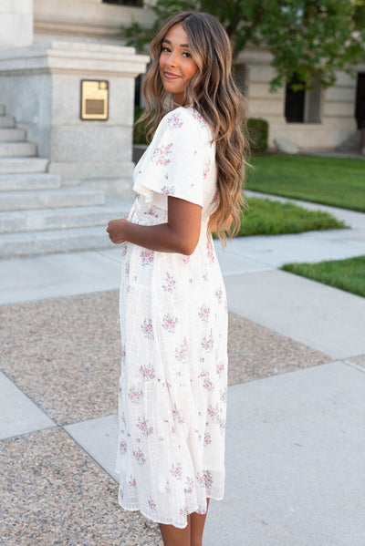 Side view of the cream floral tiered dress