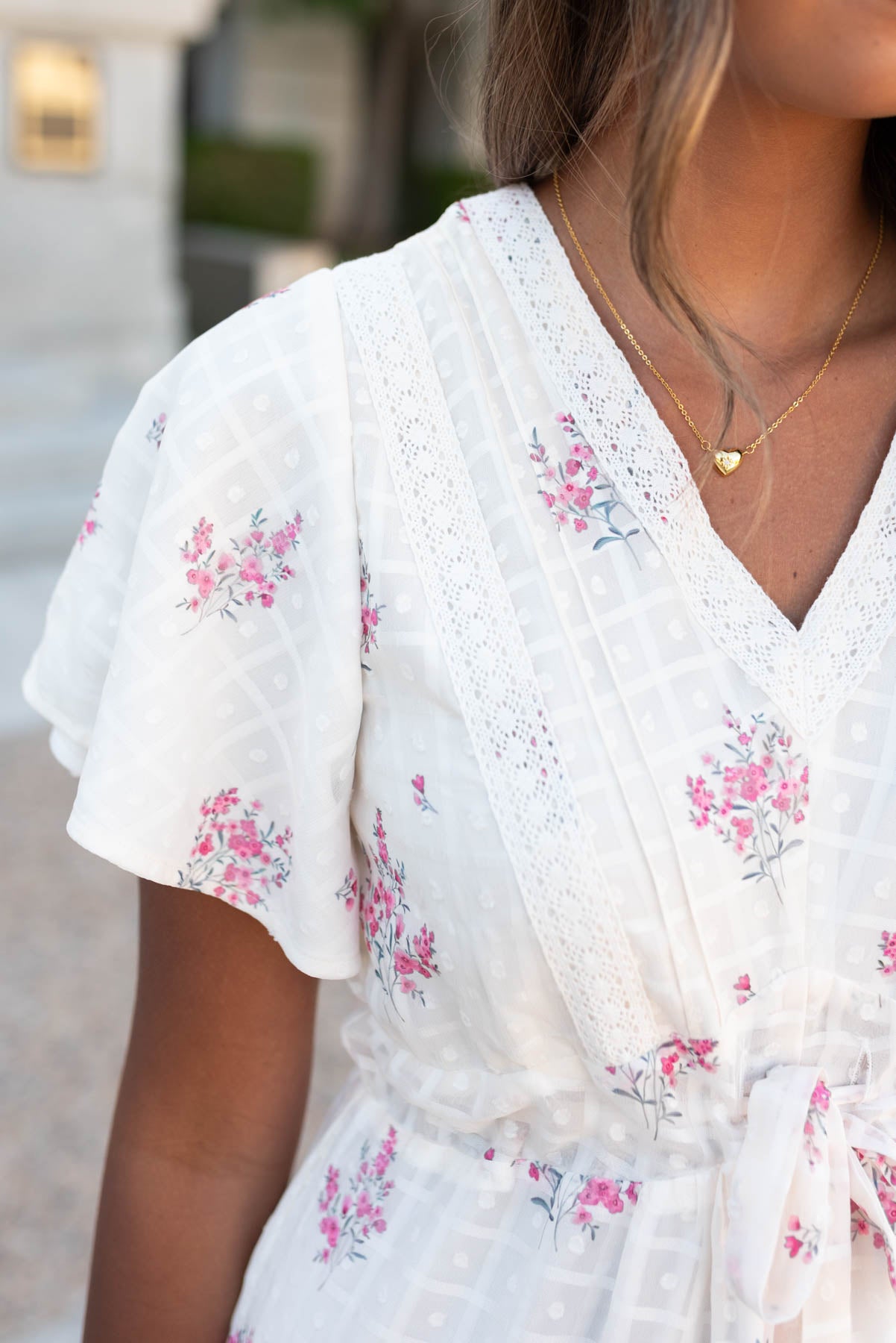 Close up of the fabric and lace on the cream floral tiered dress