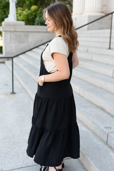 Side view of the black overall dress