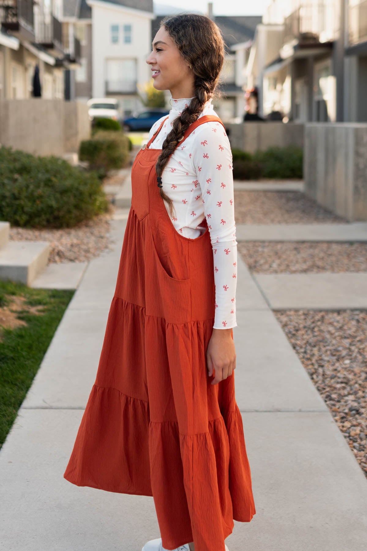 Side view of the rust overall dress