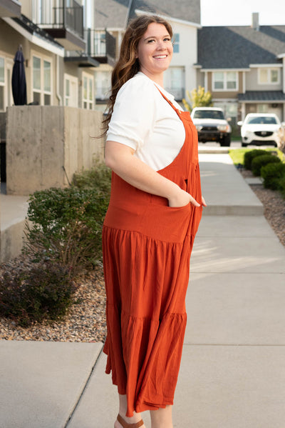 Side view of the plus size rust overall dress