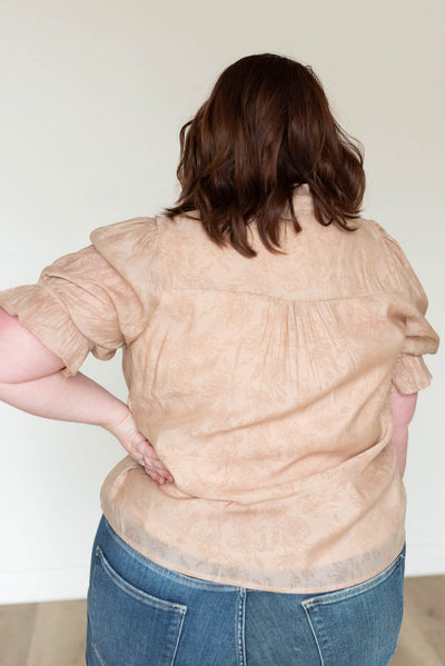 Back view of the taupe floral blouse in plus size