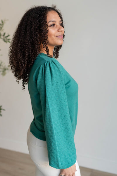 Side view of the green textured sweater