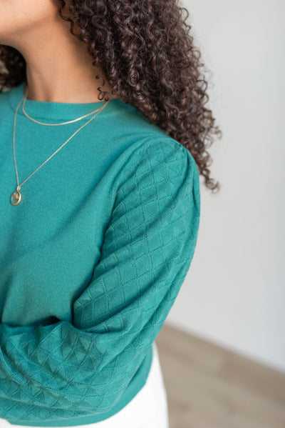 Close up of the green textured sweater