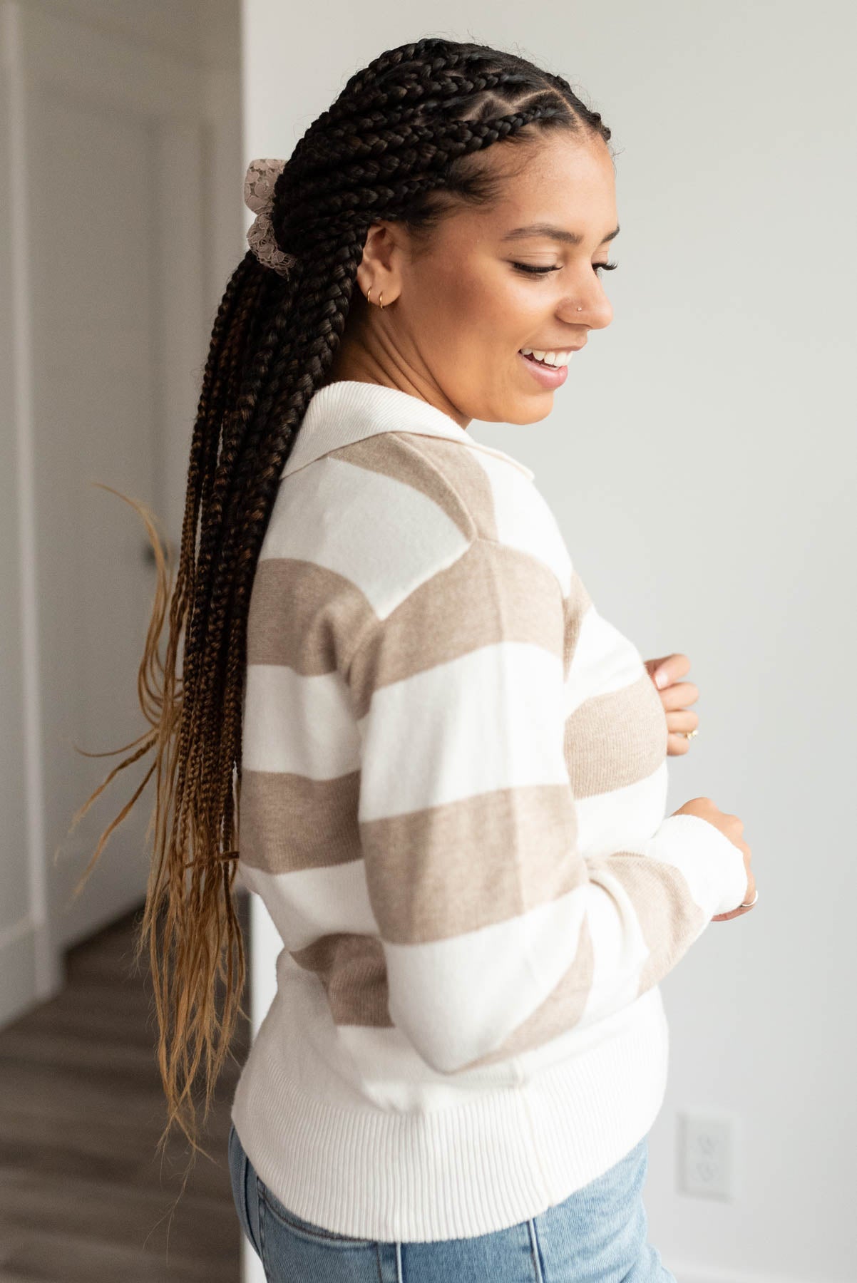 Side view of the taupe stripe collared sweater