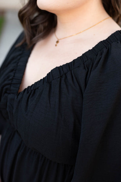 Close up of the plus size black tiered maxi dress