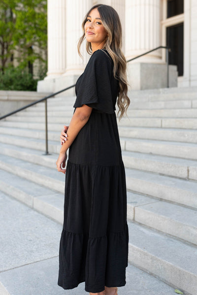 Side view of the black tiered maxi dress