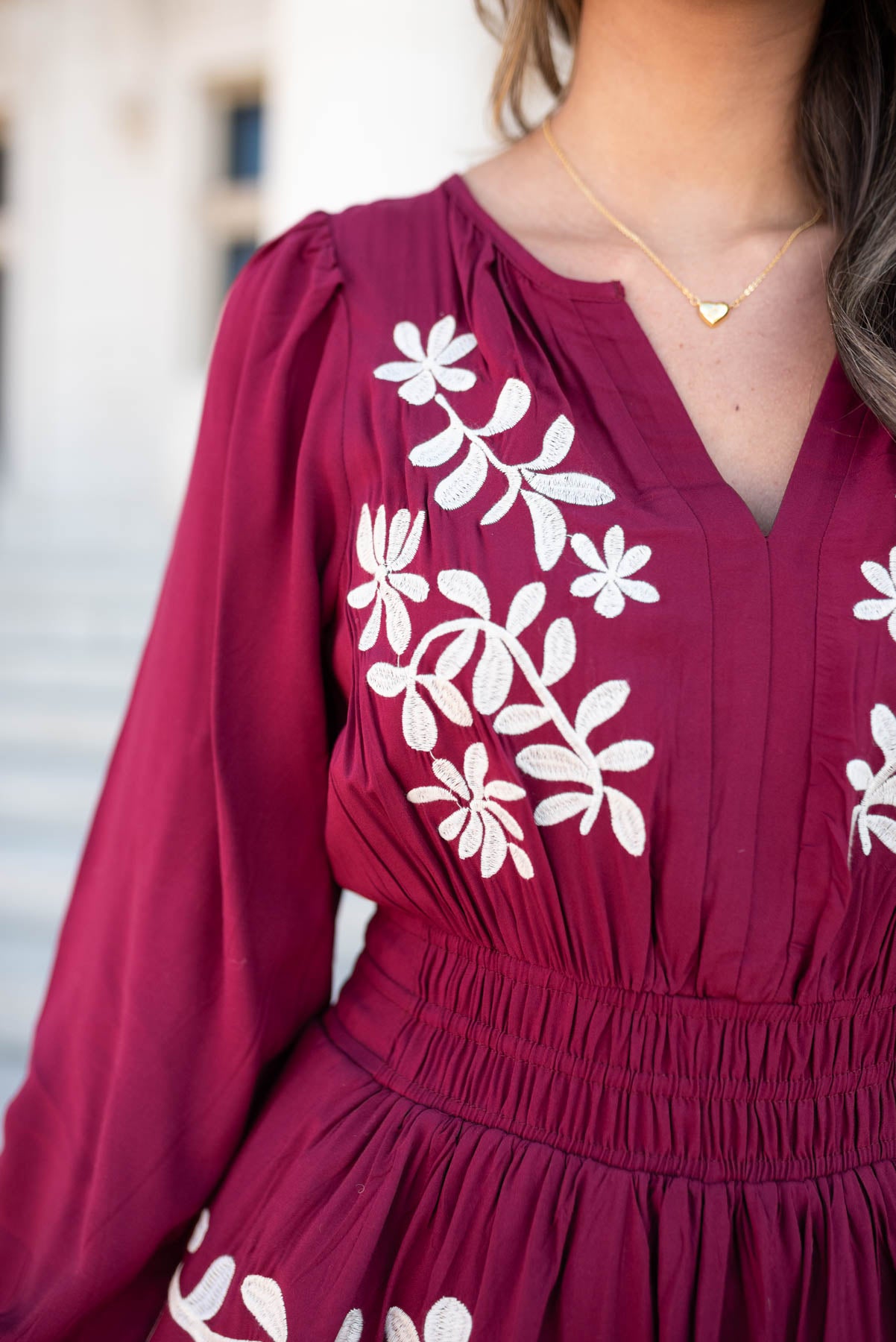 Close up of the ivory embroidery on the  wine floral embroidered dress