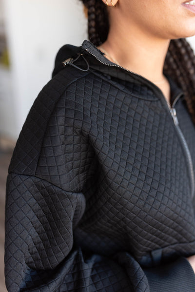 Black quilted half zip pullover with elastic frog closer on hoddie