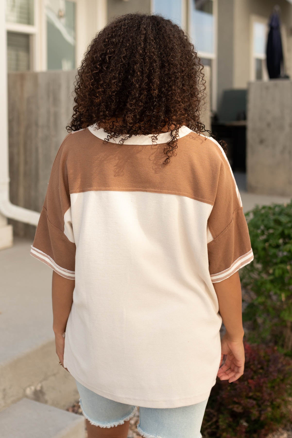 Back view of the tan mixed pattern top