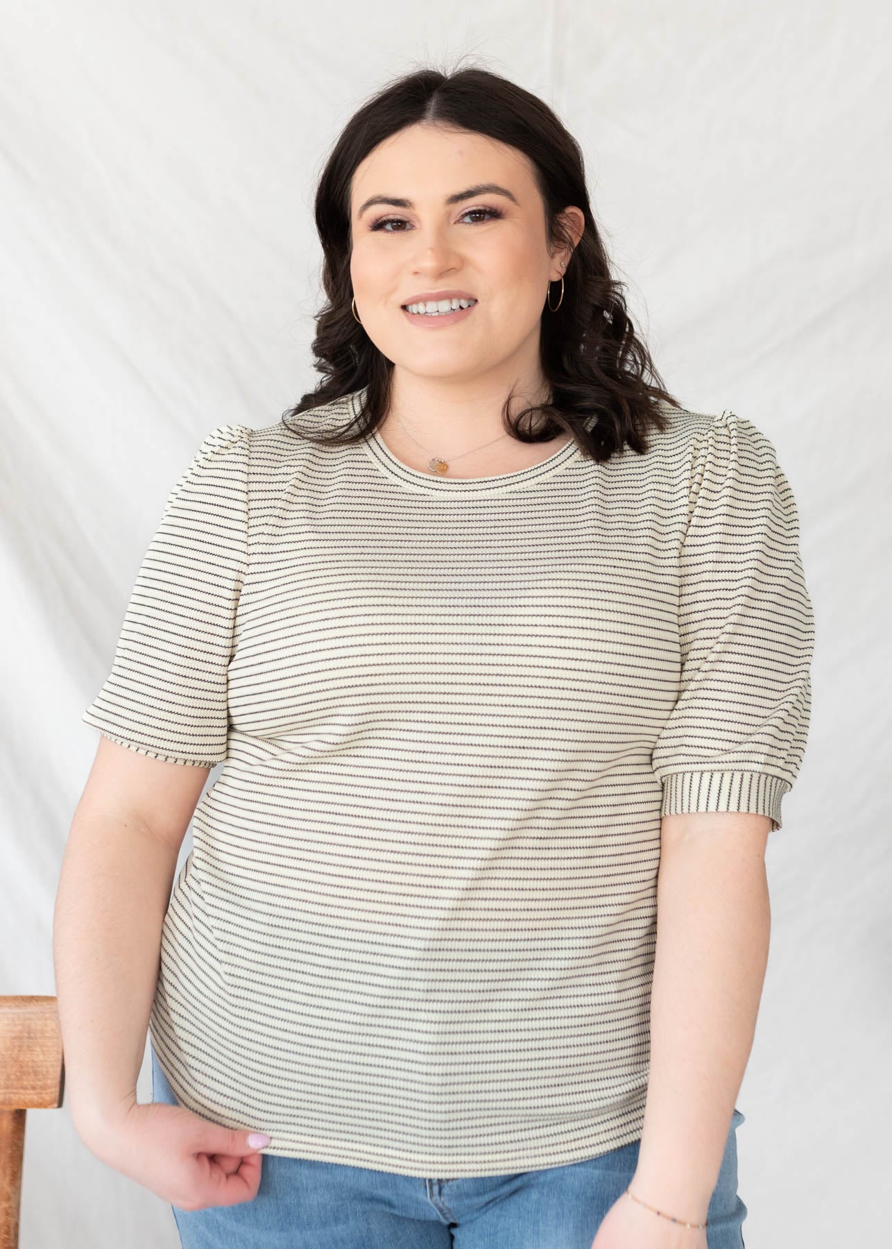 Front view of the plus size ivory striped top