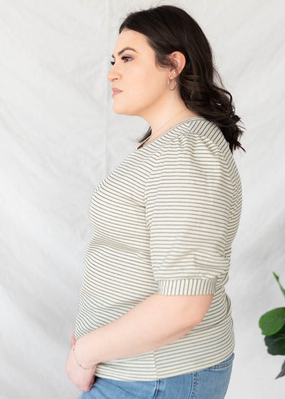 Side view of the ivory stirped top in plus size