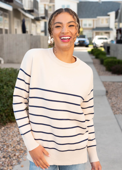 Close up of the ivory and navy stripe sweater