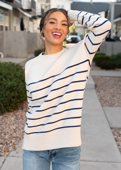 Front view of the ivory and navy stirpe sweater